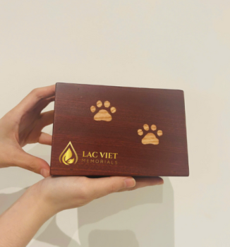 Wholesale wooden pet urn with engraved paw design from Vietnam